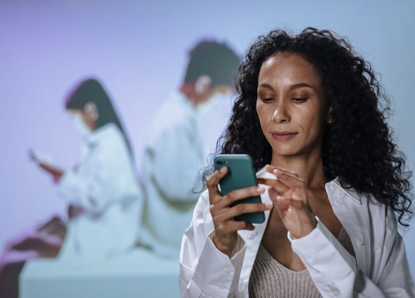 Woman smiling while typing a message on her phone